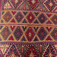 Color detail in dark red, gold, and brown on oriental tribal carpet