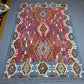 Vibrant wool Kilim rug shown on floor in boho-style decor