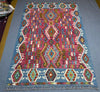 Vibrant wool Kilim rug shown on floor in boho-style decor