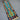  Flatweave tribal rug in teal and navy laid on wooden floor