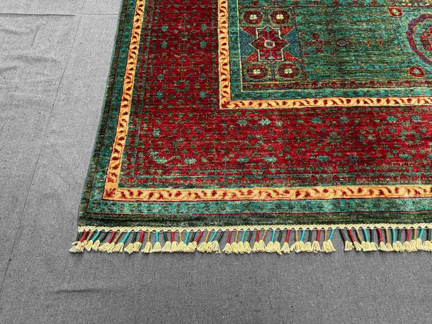 Corner detail of 6x8 red and teal Mamluk wool rug with geometric design