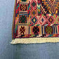 Corner detail of antique tribal kilim rug – intricate flatweave design