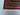 Corner detail of handmade Oriental rug with geometric red and green motifs