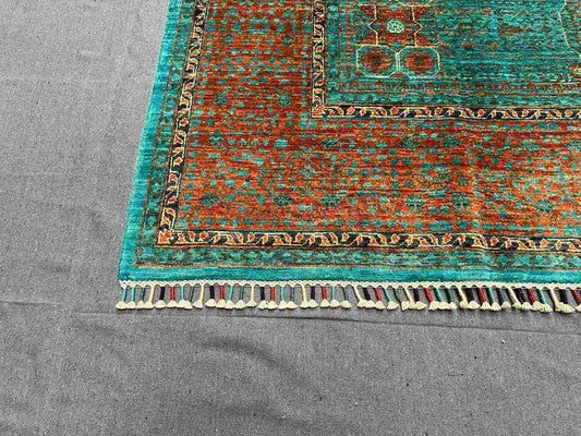 Corner pattern detail of handmade 6x8 green and orange Mamluk rug