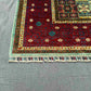 Corner detail of handmade 6x8 red and teal Mamluk rug