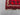 Corner detail of small vintage red Afghan Kilim rug – handmade wool with tribal geometric pattern.