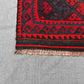 Corner detail of vintage small red Kilim rug – tribal geometric design with wool flatweave texture.