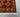 Corner detail of handmade 4x6 tribal Oriental rug showing vibrant red and orange design