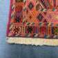 Corner close-up of antique kilim rug showing intricate tribal design