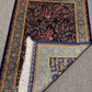 Corner shot showing knotted detailing on luxury Persian silk carpet
