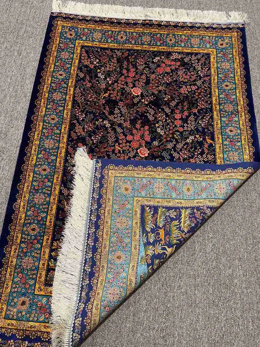 Corner shot showing knotted detailing on luxury Persian silk carpet