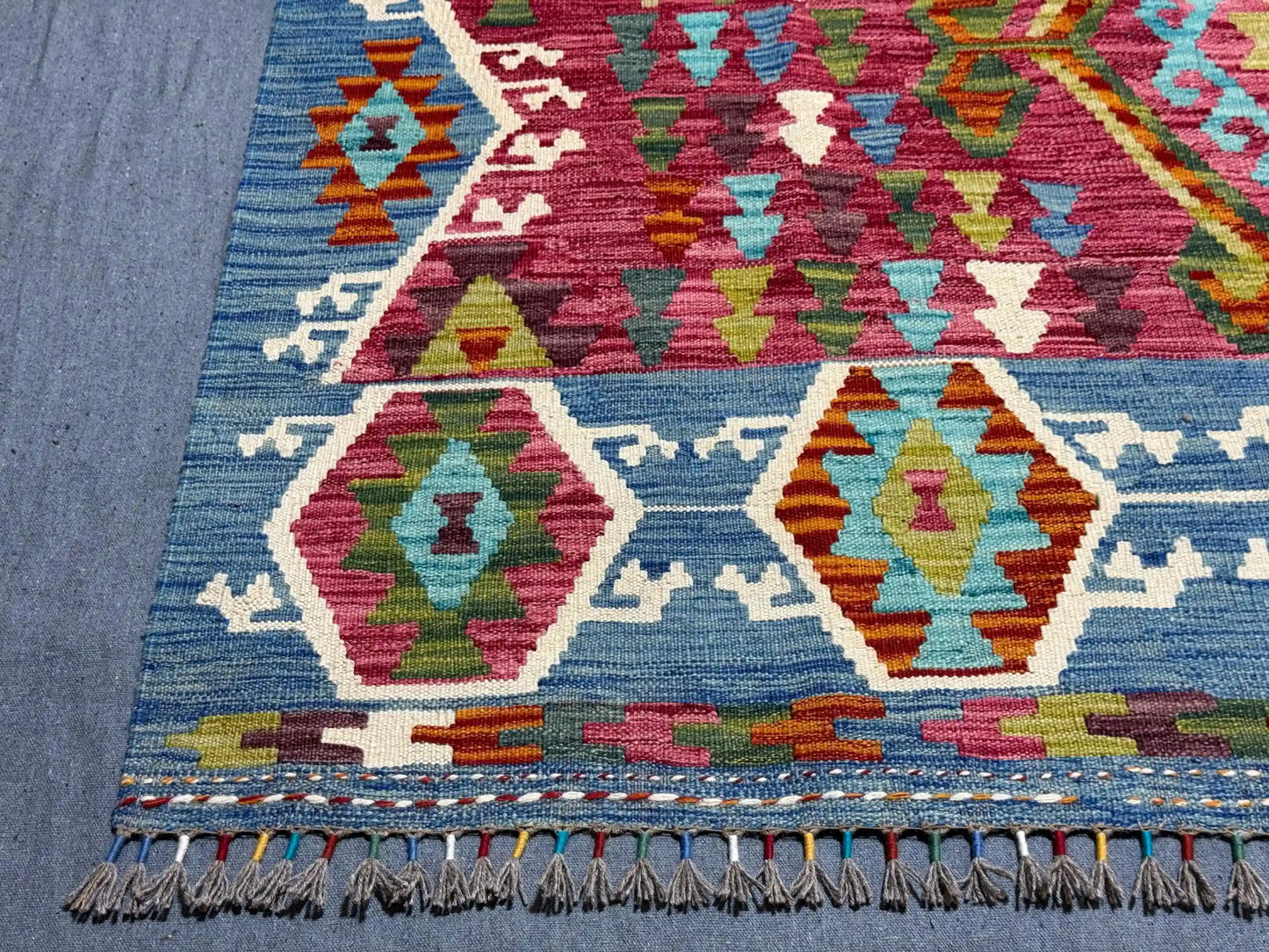 Corner detailing of Turkish flatweave Kilim with vibrant tribal patterns.