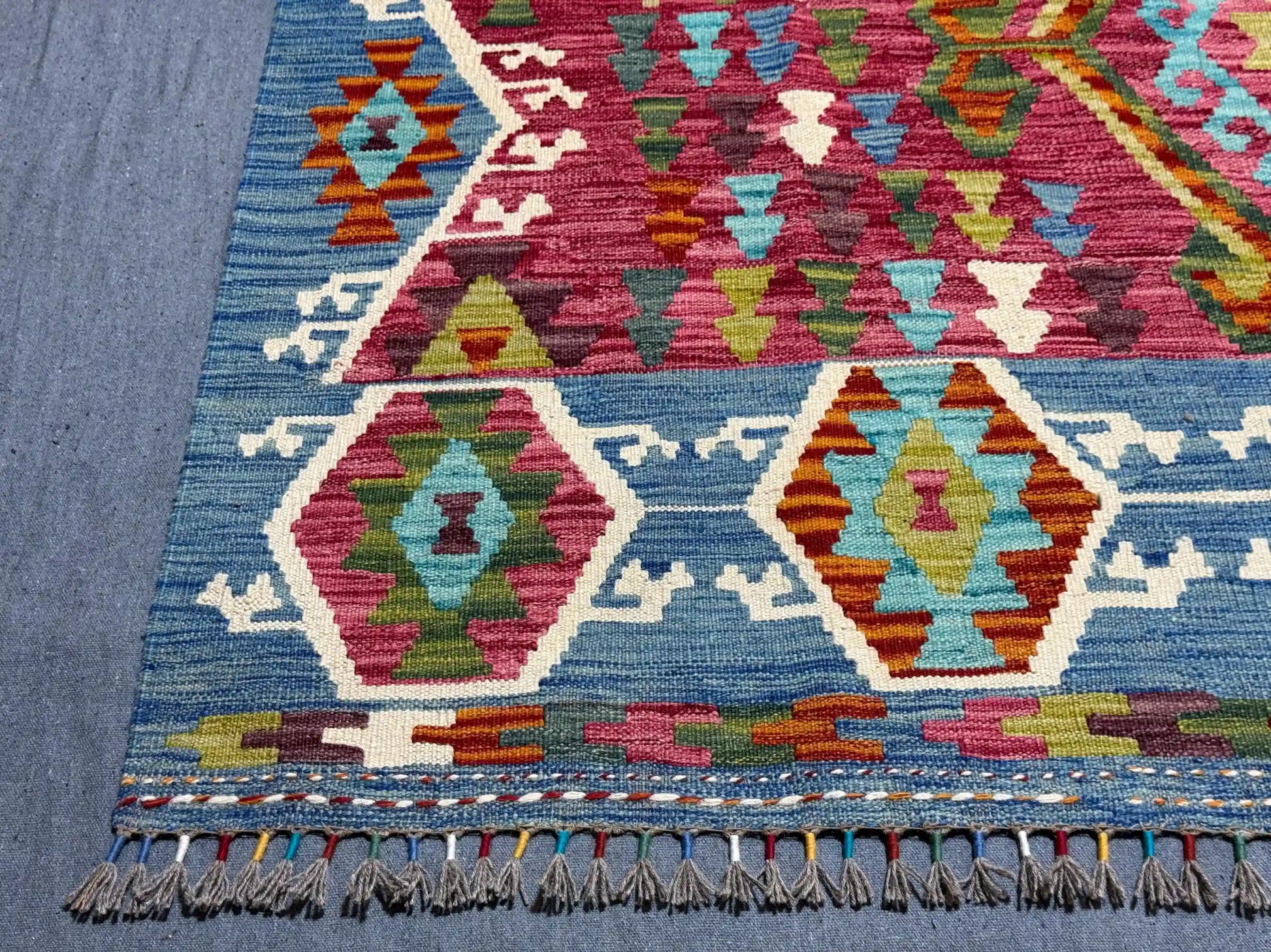 Corner detailing of Turkish flatweave Kilim with vibrant tribal patterns.