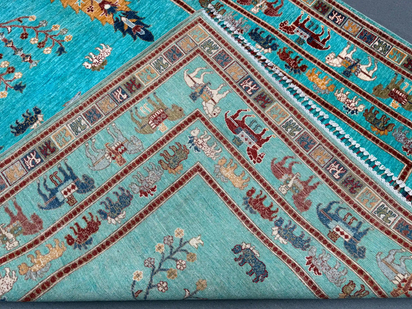 Edge fold detail of Tree of Life handmade turquoise wool rug
