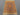 Turkish Afghan rug laid on floor in living space with beige and brown tribal motifs
