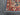 Close-up of floral design on Turkish-style red and blue rug