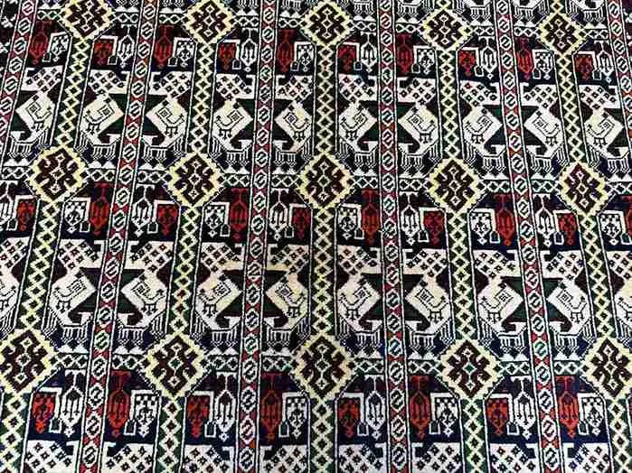Close-up of floral and geometric patterns on Persian-style handmade rug