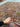 Handmade Persian wool rug in hands – floral front view