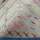Folded view of pastel Afghan kilim showing soft wool craftsmanship