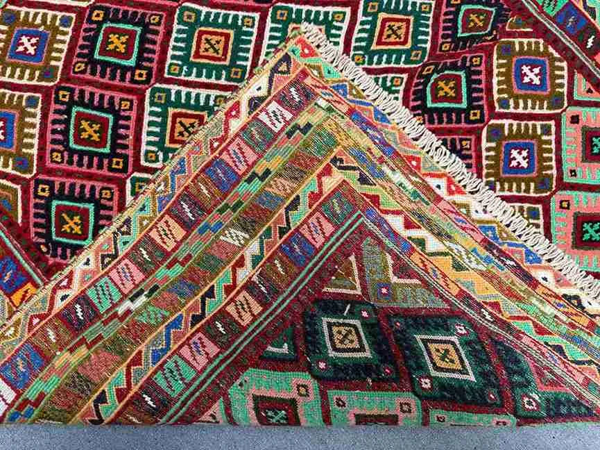 Folded view of Afghan tribal kilim rug showing edge detail