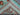 Back view of folded aqua blue wool Sultani rug