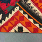 Folded view showing backside of multicolor Turkish Kilim rug – vintage hand-knotted wool.