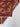 Folded view highlighting corner of red handmade tribal carpet