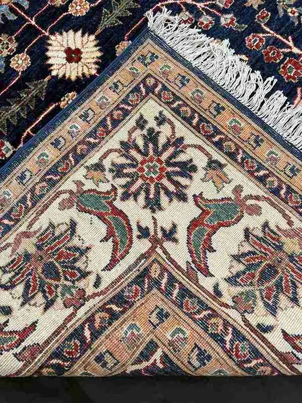 Folded handmade Chobi rug showing wool thickness and quality