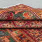 Folded 6x8 handmade Pazyryk wool rug in red and blue tones