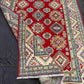 Folded view of handmade 5x7 Kazakh wool rug showcasing texture