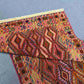 Folded Turkish kilim runner rug showing wool quality and color