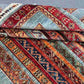 Folded Turkish kilim showing wool texture and striped floral design