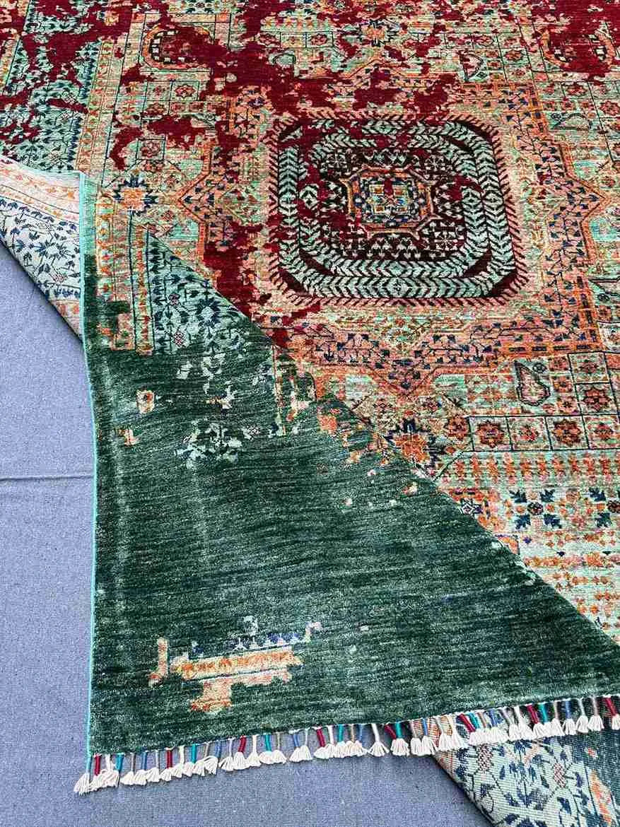 Folded view of modern abstract Mamluk rug showing texture