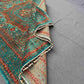 Folded side view of hand-knotted wool silk Mamluk rug