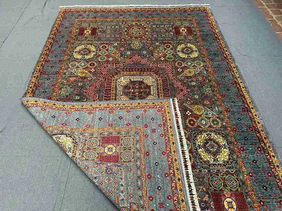 Folded view of handmade Turkish Mamluk rug showing side texture