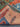Folded Persian rug showing lake and wildlife design on thick wool