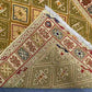 Folded Persian kilim rug showing olive and gold tribal craftsmanship
