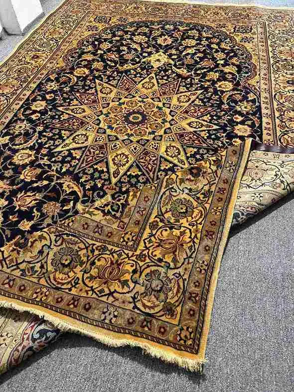 Edges of folded Nain rug displaying craftsmanship
