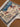 Folded view of Persian silk rug – hunting scene visible, hand-knotted finish