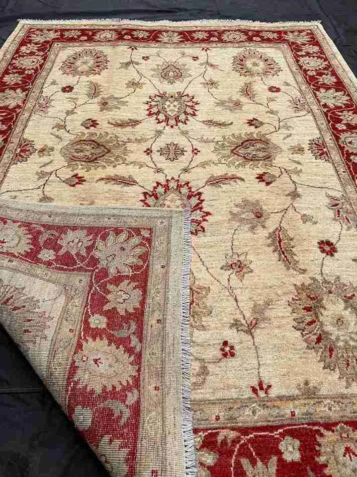 Close-up of folded Persian-style rug showing texture and design