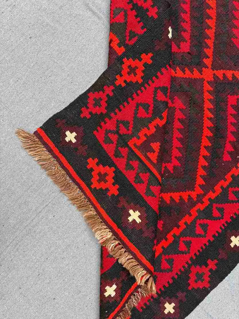 Folded handmade Turkish Kilim rug – red and black wool flatweave with tribal design
