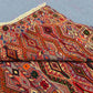 Side view of folded tribal kilim rug showing wool construction and vibrant colors