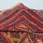 Folded side view of 3.10x4.3 Turkish Afghan kilim rug showing wool edges