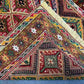 Folded side view of Turkish Afghan runner rug showing woven wool edges