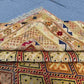 Folded side view of Afghan Turkish wool rug showing edge detail and weave