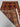 Folded view of red and orange tribal rug showing back weave and knotting style