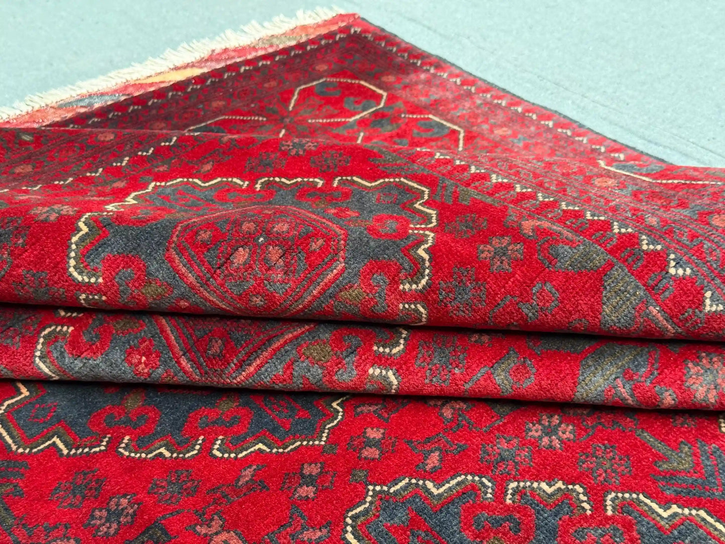 Folded view showing soft wool texture on Afghan-style rug