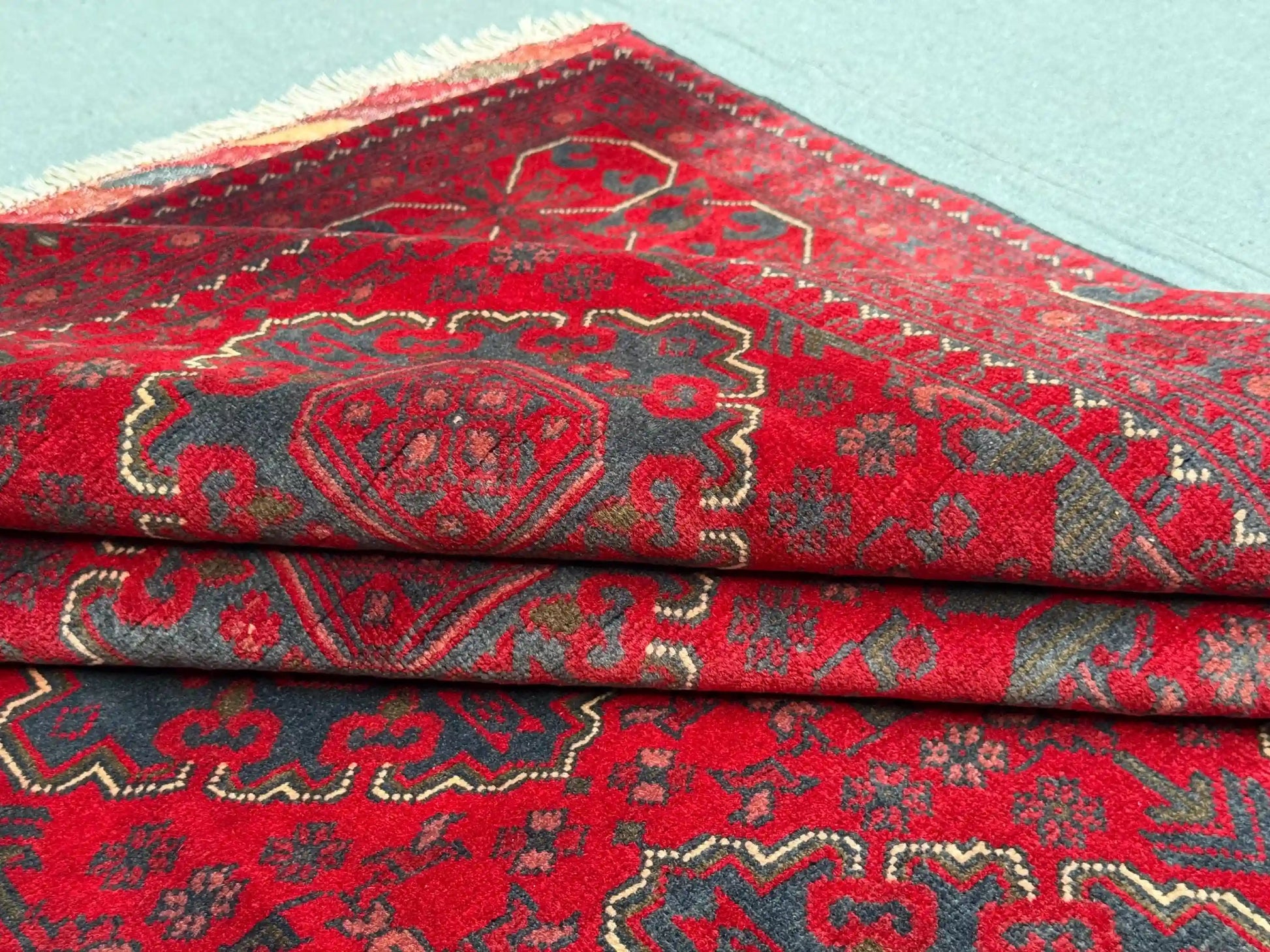 Folded view showing soft wool texture on Afghan-style rug