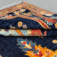 Folded view of Tree of Life rug showing texture and color