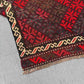 Folded view of vintage Afghan Kilim rug – vibrant red small wool flatweave ideal for gifting.
